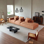 "Philips Modern European Chic Style Sofa Made with Cobblestone Fabric -2  \nModern living room with a brown sectional sofa, coffee table, and decorative items."