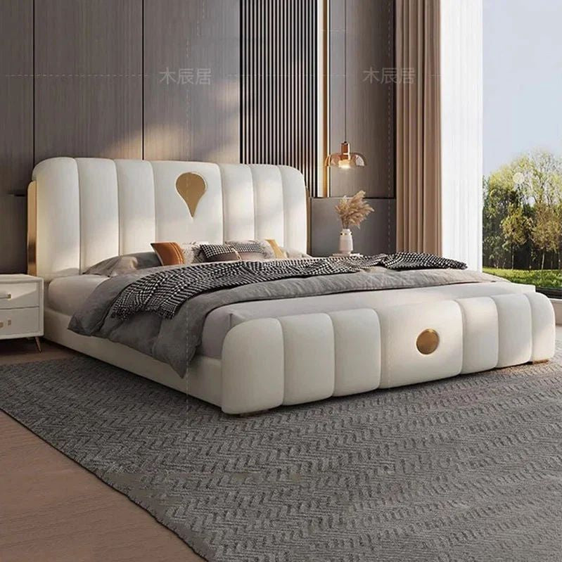 "Modern bedroom with a white upholstered bed and decorative pillows."
