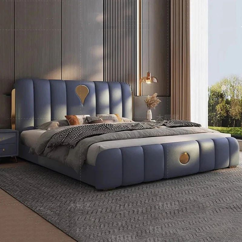"Modern bedroom with a blue upholstered bed and decorative pillows."