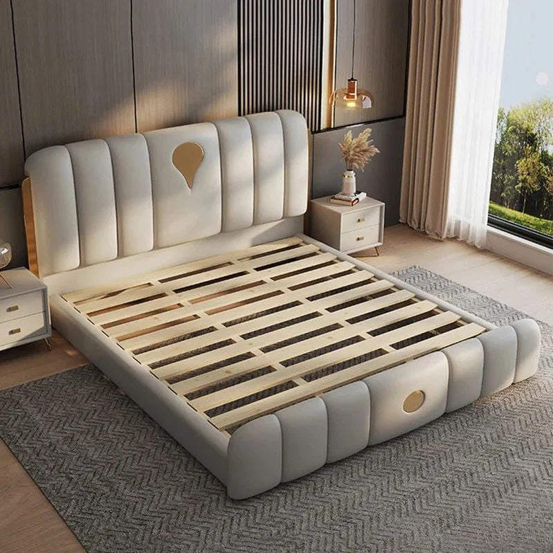 "Modern bedroom with a gray upholstered bed and wooden slats"