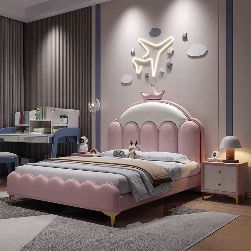 "Pink children's bed in a bedroom with a desk and decor."