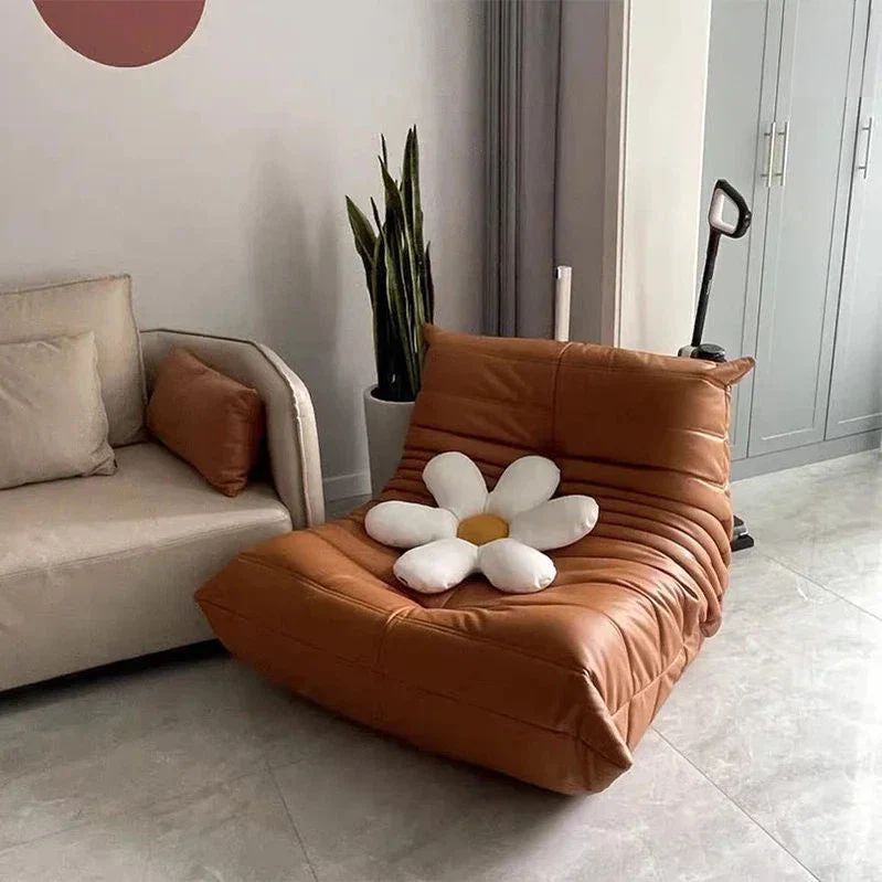 "Brown cushioned chair with a flower-shaped pillow in a living room setting."