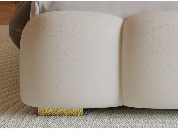"Modern Upholstered Lighted Bed with Storage Drawers Compartments Beige sofa with a gold trim on a carpeted floor"
