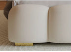 "Modern Upholstered Lighted Bed with Storage Drawers Compartments Beige sofa with a gold trim on a carpeted floor"