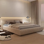 "Ribbed Upholstered Low Profile Bed Frame \nModern bedroom with a large bed, nightstands, and decorative pillows."