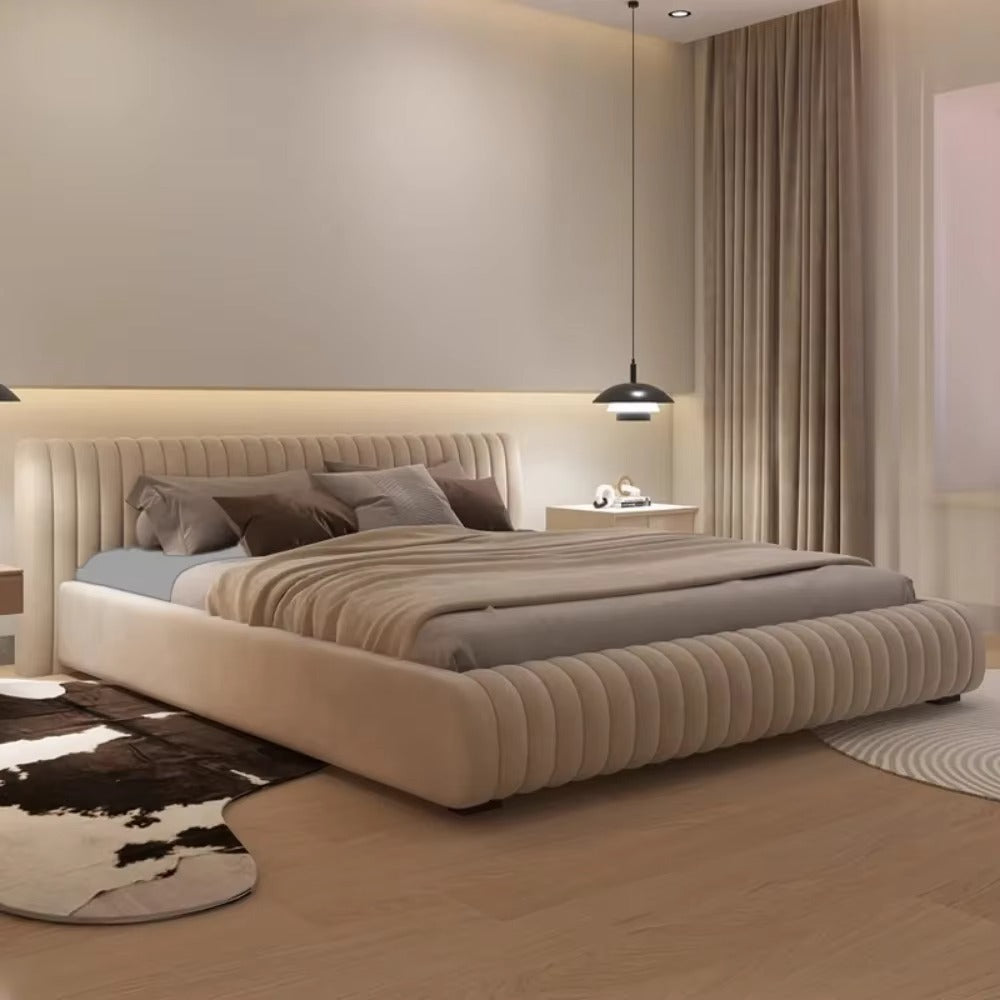 "Ribbed Upholstered Low Profile Bed Frame \nModern bedroom with a large bed, nightstands, and decorative pillows."