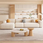 "Multifunctional Relaxing Living Room Sofas Replica Gaming Nordic Accent Living Room Sofas Armchair \nModern living room with a white sofa, wooden coffee table, and shelves in the background."