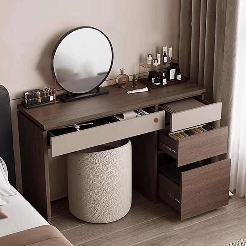 "Dressing table with round mirror and various items in a bedroom setting"