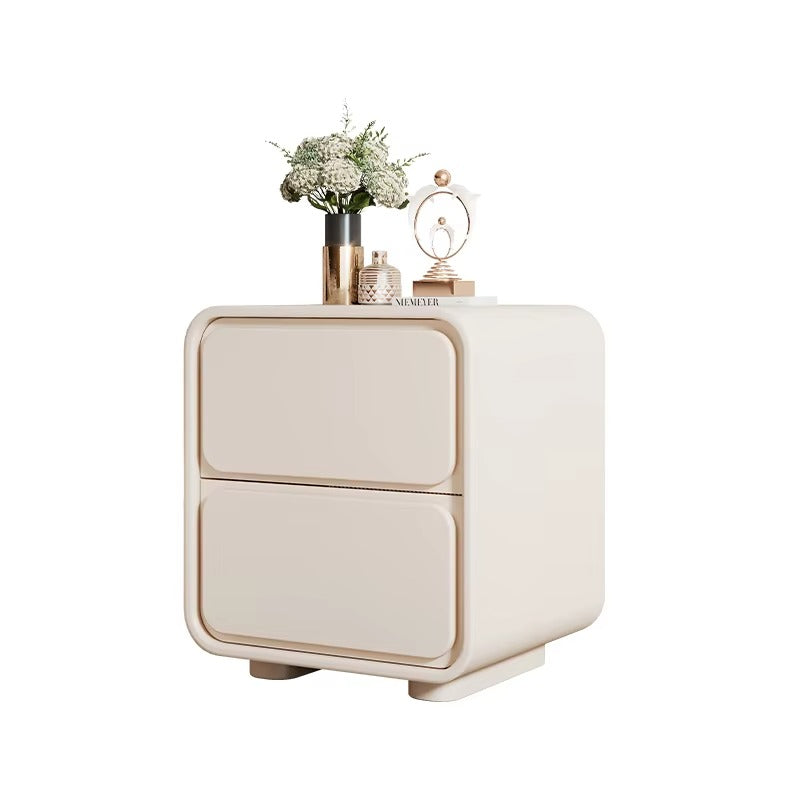 "Beige nightstand with decorative items on a white background"