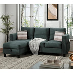"Green sectional sofa in a living room with a plant and coffee table."
