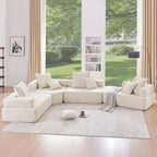"Modern living room with a large sectional sofa, coffee table, and large windows."