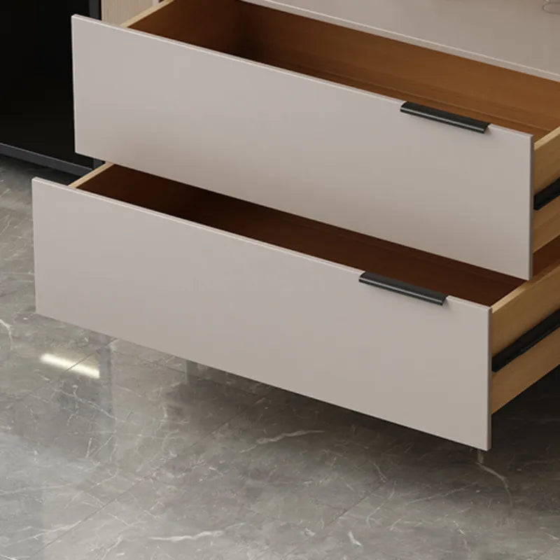 "Close-up of a wooden drawer with a metallic handle on a marble floor."