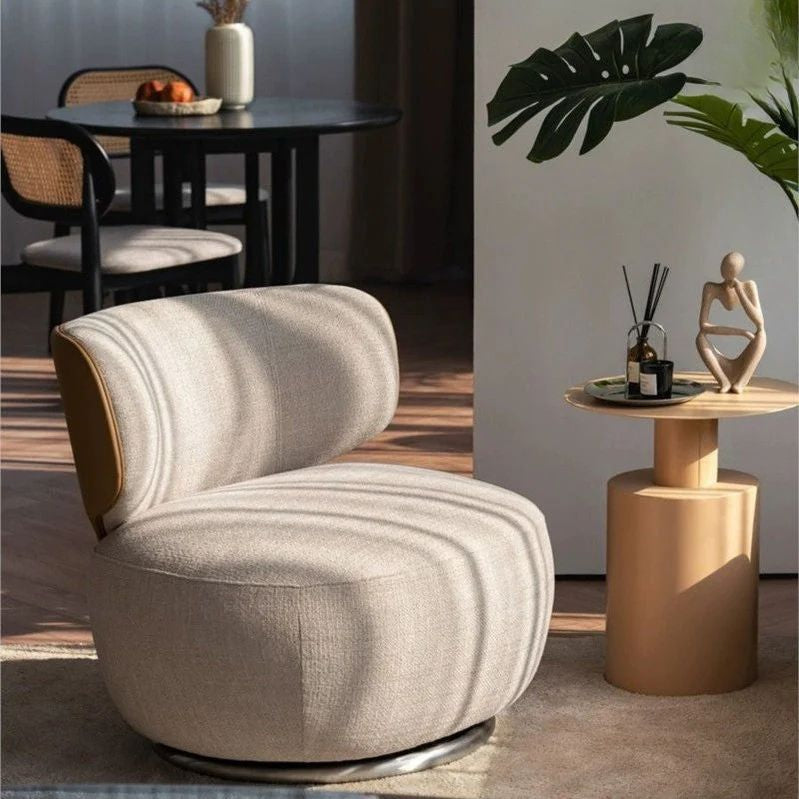 Modern beige chair in a stylish room with a side table and decorative items.
