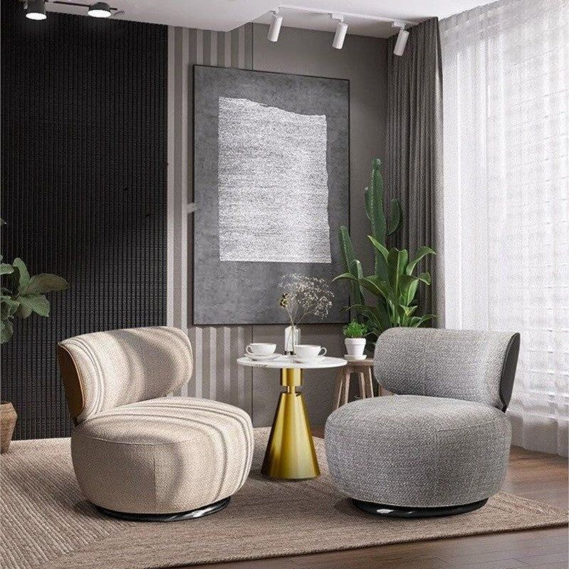 "Advanced Swivel Lazy Leisure Chair Made with Fabric. \nModern living room with two armchairs, a small round table, and decorative elements."