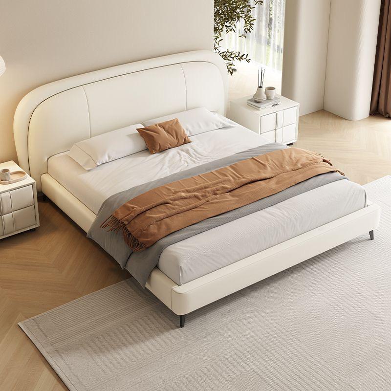 Modern bedroom with a white upholstered bed and brown bedding. Minimalist bedframe, Upholstered bed, Aesthetic modern design bed. 