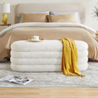 Stack of folded towels with a yellow towel draped over them next to a neatly made bed. Storage bench for bedroom, Outdoor storage bench, Entryway bench with storage.