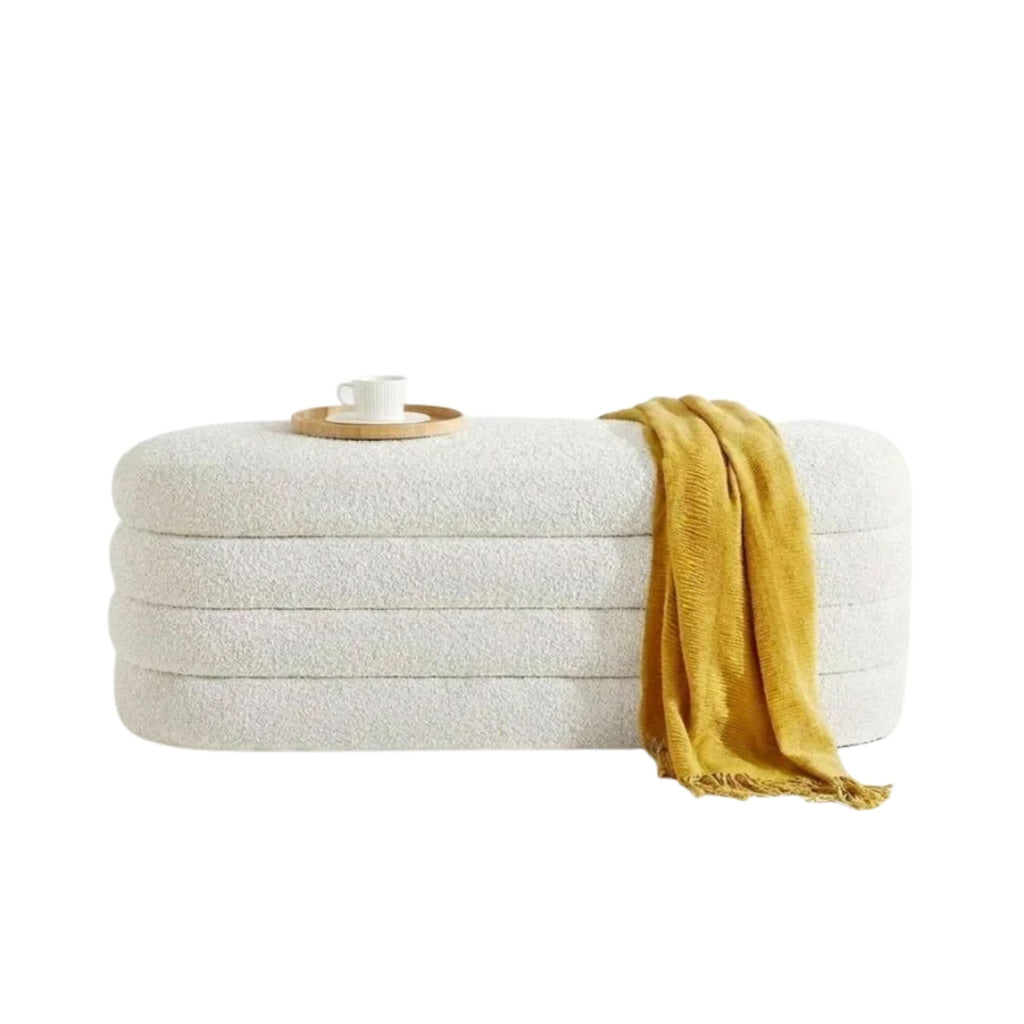 Stack of white towels with a yellow towel draped over them on a white background