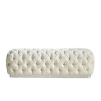 Tufted cream-colored bench on a white background