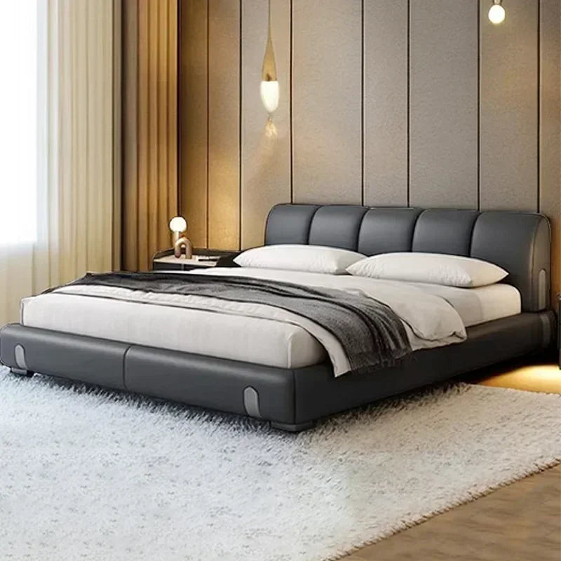 Modern bedroom with a gray upholstered bed and decorative pillows.