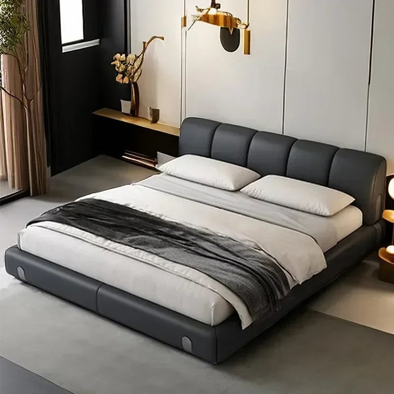 Modern bedroom with a gray upholstered bed and white bedding.