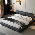 Modern bedroom with a gray upholstered bed and white bedding.