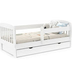 White children's bed with a trundle and toys on a white background