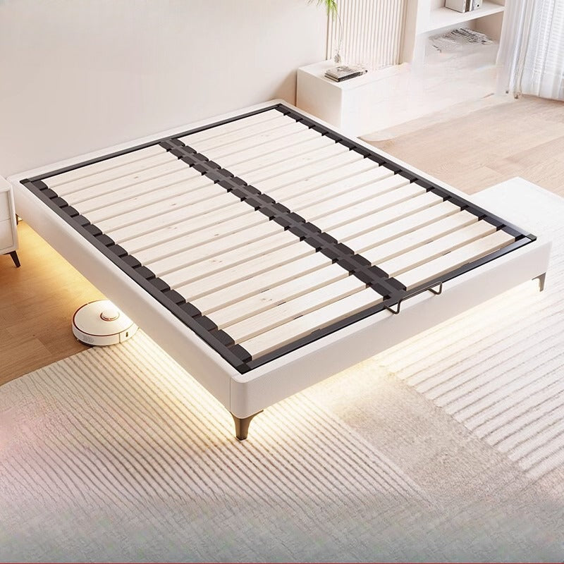 White bed frame with black slats in a modern bedroom setting