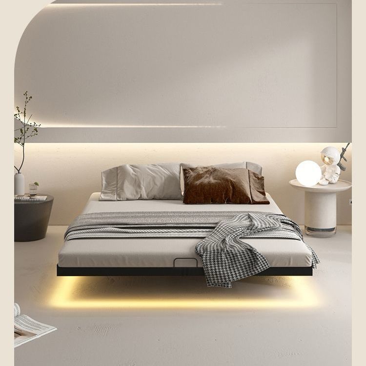 Modern bedroom with a floating bed design, minimalistic decor, and soft lighting. Floating bedframe, metal bedframe, minimalist bedframe. 