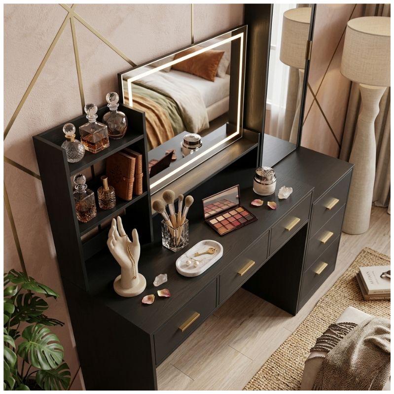 Black vanity table with mirror and various items in a bedroom setting