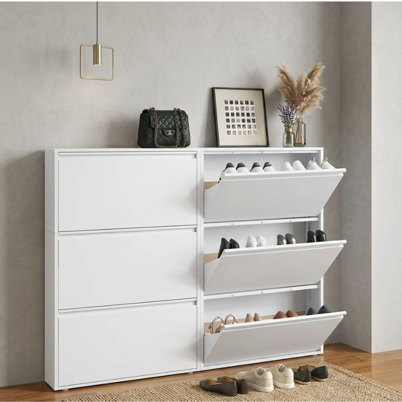 White shoe cabinet with multiple shelves and drawers in a room setting.