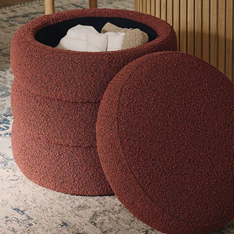Two round brown ottomans on a textured rug.