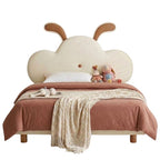 Children's bed with cloud-shaped headboard and plush toys on a white background