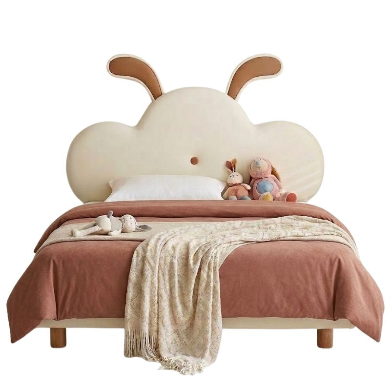 Children's bed with cloud-shaped headboard and plush toys on a white background