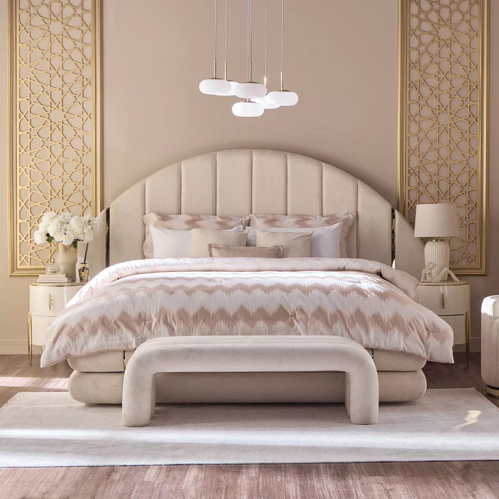 "Luxurious bedroom with a large bed, decorative pillows, and elegant wall designs."