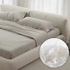 Beige bed sheets on a bed with a close-up of the fabric texture.