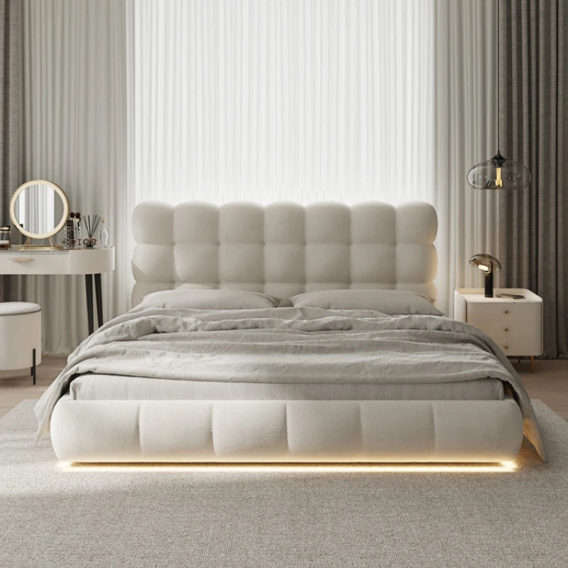 Modern bedroom with a tufted bed and LED strip lighting