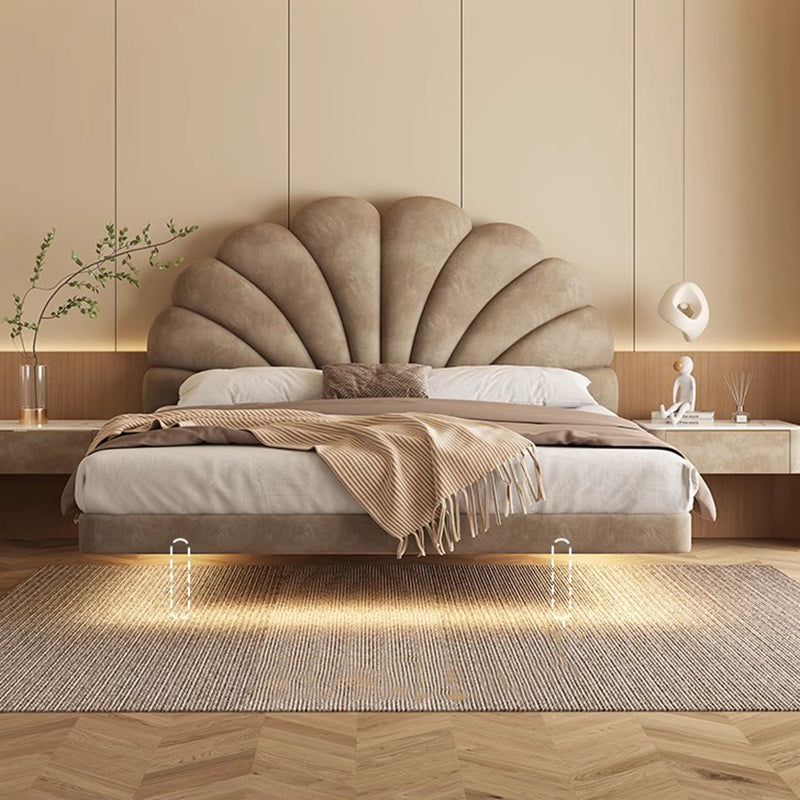 Beige shell-shaped headboard bed in a bedroom setting with decor elements. Floating bed, Modern Bedframe design, Bedframe with LED, Minimalist bedframe design, aesthetic bedframe design, modern bedroom design. 