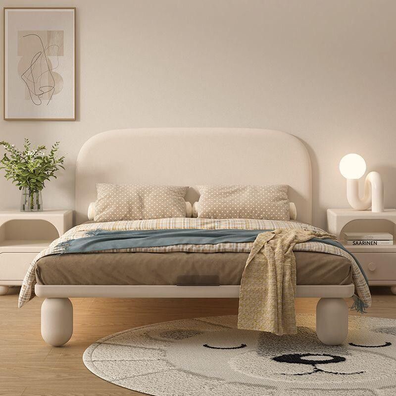 This Luxury Upholstered King Bed embodies contemporary sophistication with its gracefully curved headboard and premium fabric finish. The soft beige tones and vertical panel detailing create an elegant statement piece that brings both comfort and style to any modern bedroom. Crafted with precision, it offers a sturdy frame and plush upholstery for a truly relaxing sleep experience. Perfect for those who appreciate refined aesthetics and quality craftsmanship.