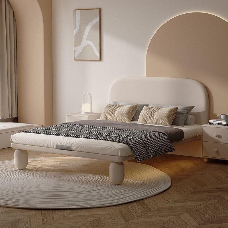 This Luxury Upholstered King Bed embodies contemporary sophistication with its gracefully curved headboard and premium fabric finish. The soft beige tones and vertical panel detailing create an elegant statement piece that brings both comfort and style to any modern bedroom. Crafted with precision, it offers a sturdy frame and plush upholstery for a truly relaxing sleep experience. Perfect for those who appreciate refined aesthetics and quality craftsmanship. 