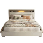 Beige upholstered bed with floral bedding on a white background