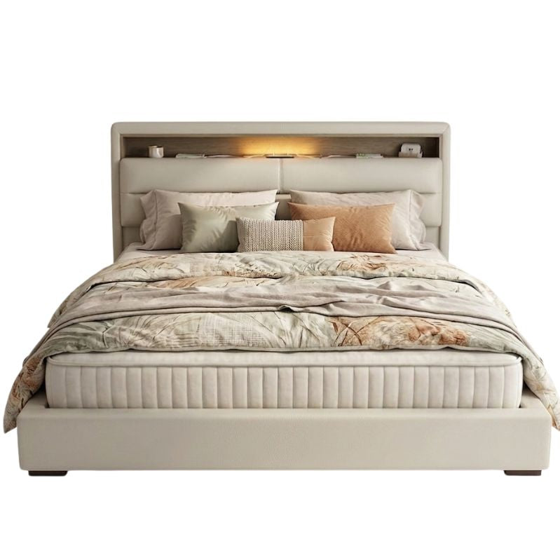 Beige upholstered bed with floral bedding on a white background