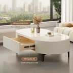 Round white coffee table with storage drawers in a living room setting