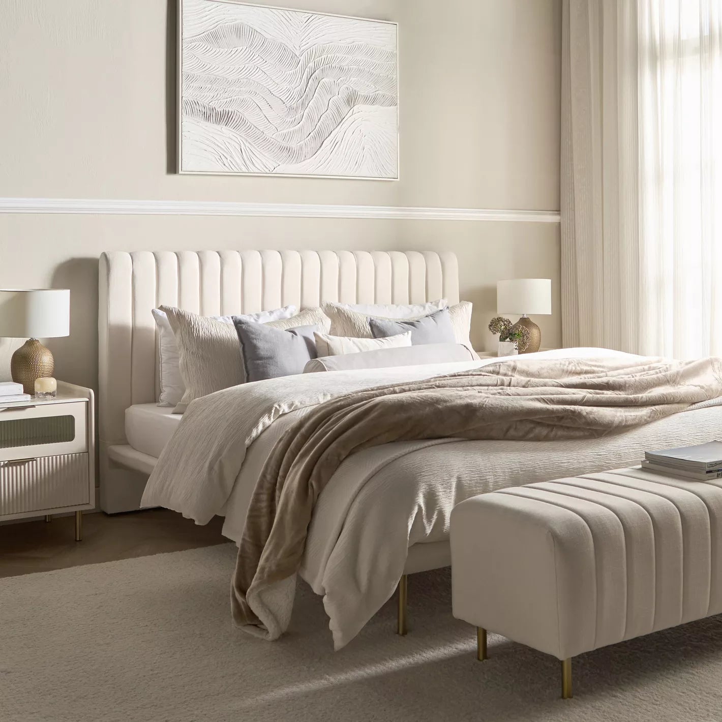 "Neatly made bed in a bedroom with a side table and lamp."