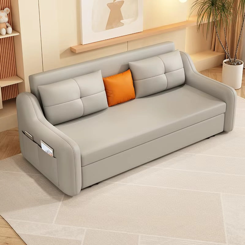 Gray sofa with orange pillow in a living room setting. Modern leather sleeper sofa, Pull out sofa, Living room  sofa. 
