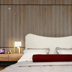 "Modern upholstered bed. Bedroom with striped wall, nightstand, and lamp."