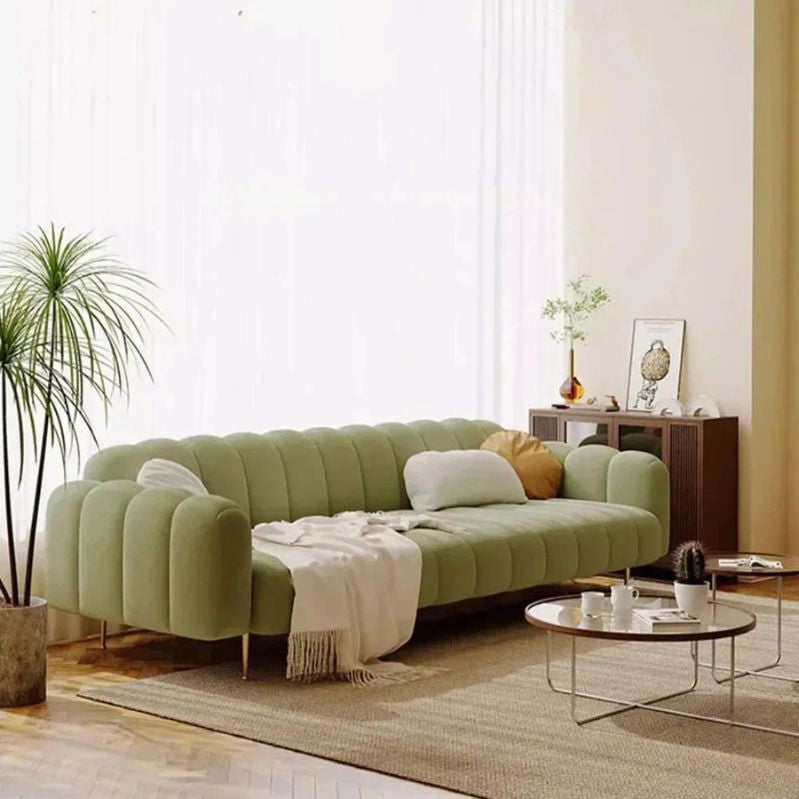 Green sectional sofa in a living room with a coffee table and decorative items. Sectional sofa, Premium sofa, living room sofa, wood furniture, minimalist sofa design, aesthetic modern sofa. 