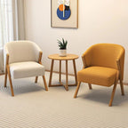 Two armchairs, one beige and one yellow, with a small round table in a room.