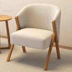 Beige armchair with wooden legs in a room setting