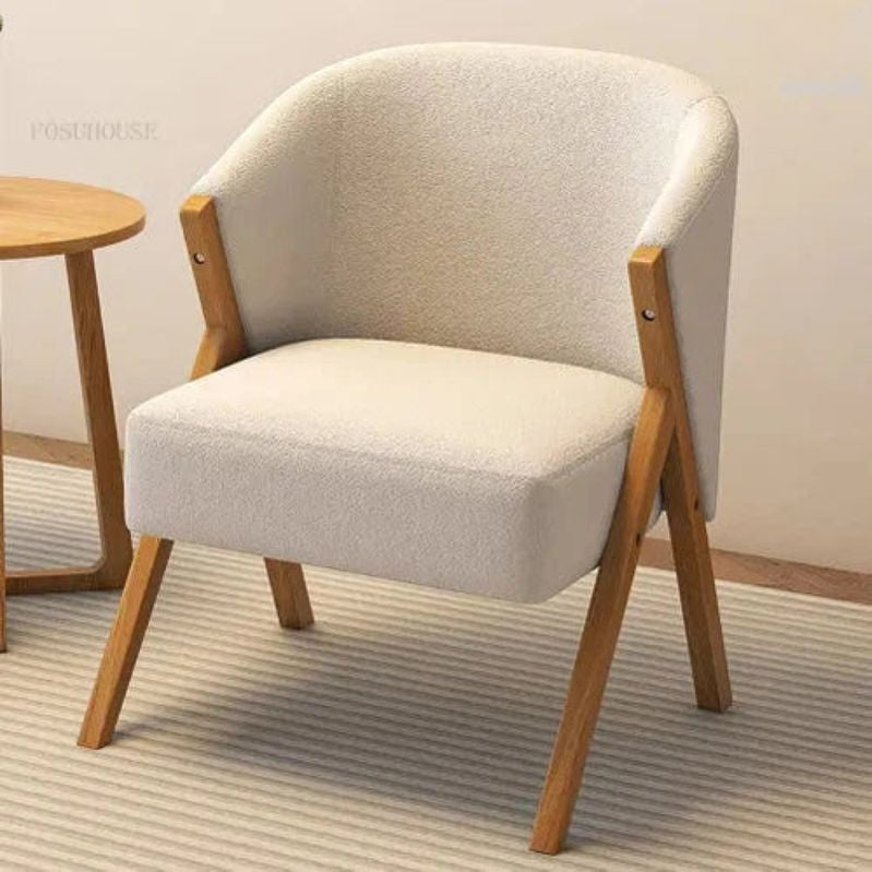 Beige armchair with wooden legs in a room setting