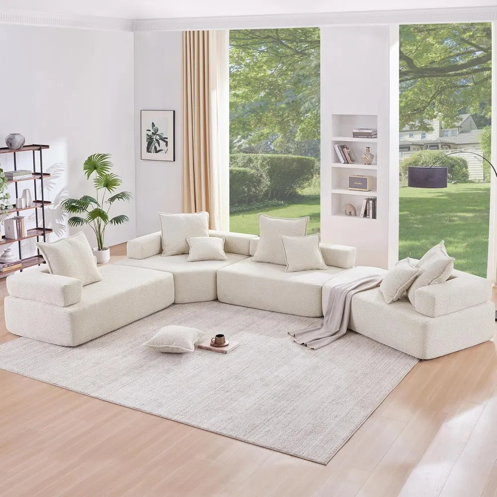 Modern living room with a large white sectional sofa, bookshelves, and large windows. Comfortable sofa, Living room sofa, Sleeper and comfortable sofa. 